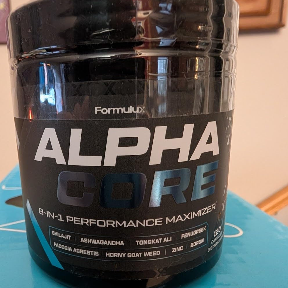 Supplement container labeled 'Alpha Core' on a blue surface